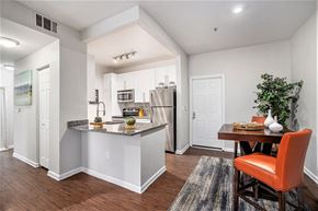 Glendale apartment for rent - A kitchen with a bar area and a dining table with chairs.