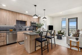 Denver apartment for rent - an open kitchen with a bar and a living room
