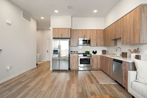 Los Angeles apartment for rent - A modern kitchen with wooden cabinets and stainless steel appliances.
