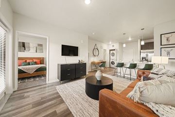 Colorado Springs apartment for rent - A living room with a brown couch and a black coffee table.