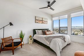 Denver apartment for rent - a bedroom with a bed and a ceiling fan     and a view