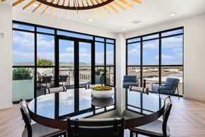 Denver apartment for rent - A modern dining room with a glass table and chairs.