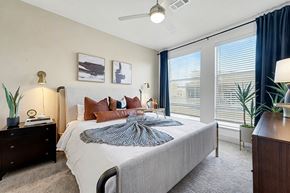 Aurora apartment for rent - A bedroom with a large bed and a ceiling fan.