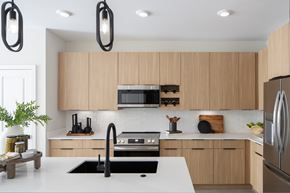 Ashburn apartment for rent - A modern kitchen with wooden cabinets and stainless steel appliances.