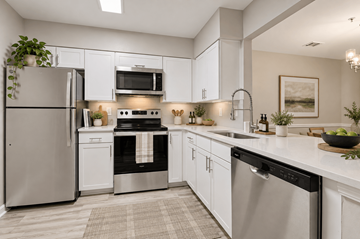 Fairfax apartment for rent - A modern kitchen with stainless steel appliances and white cabinets.