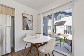 Eagle townhouse for rent - a dining area with a white table and chairs and a refrigerator