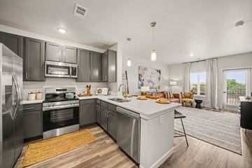 Colorado Springs apartment for rent - A modern kitchen with stainless steel appliances and a large island.