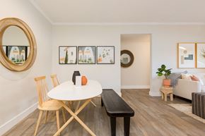 Chandler apartment for rent - a dining room with a white table and chairs and a living room