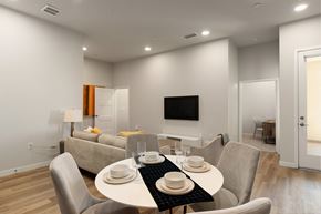 Los Angeles apartment for rent - A modern dining room with a white table and chairs.