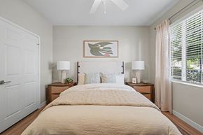 Lakewood apartment for rent - A bedroom with a large bed and two lamps on either side.