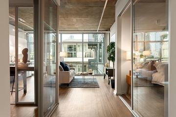 San Diego apartment for rent - A modern living room with a view of the city through large windows.
