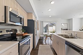 Eagle townhouse for rent - a modern kitchen with stainless steel appliances and wooden cabinets