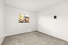 San Diego apartment for rent - A room with a window showing a view of a building outside.