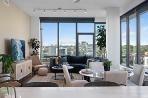 San Diego apartment for rent - Modern living room with floor-to-ceiling window and city views at Stanza Little Italy, a high-rise apartments in San Diego.