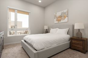 Los Angeles apartment for rent - A bedroom with a large bed, a nightstand with a lamp, and a painting on the wall.
