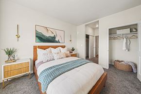 Colorado Springs apartment for rent - A bedroom with a large bed and a painting on the wall.