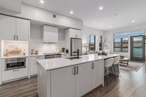 Boulder apartment for rent - A modern kitchen with white cabinets and a central island.
