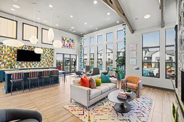 Denver apartment for rent - A living room with a grey couch and a wooden floor.