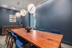 Denver apartment for rent - a dining room with a wooden table and blue chairs