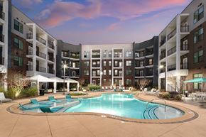 Atlanta apartment for rent - Resort-style pool and sun shelf at dusk at The Lowery Upper West Side apartments in Atlanta.