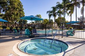 San Diego apartment for rent - A pool with a slide and a fence.