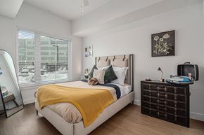 Denver apartment for rent - a bedroom with a bed and a large window