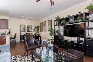 Chula Vista apartment for rent - A living room with a brown leather chair and a glass coffee table.