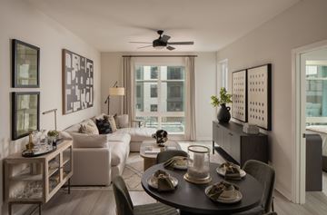 Ashburn apartment for rent - A modern living room with a dining table set for two.