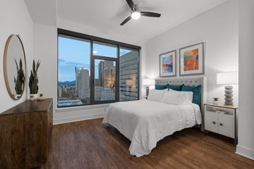 San Diego apartment for rent - a bedroom with a large bed and a large window