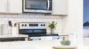 Atlanta apartment for rent - a white kitchen with a stove and a microwave