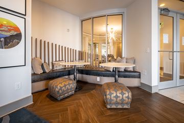 Durham apartment for rent - A living room with a couch, ottoman, and a painting on the wall.