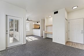 Boise apartment for rent - A spacious room with a grey carpet and white walls.