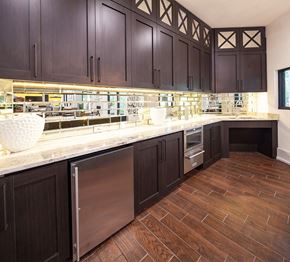 Baytown apartment for rent - A kitchen with dark wood cabinets and a marble countertop.