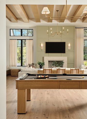 Austin apartment for rent - A living room with a pool table and a fireplace.