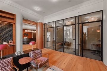 Arlington apartment for rent - A living room with a black and red chair and a wooden floor.