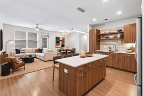 Herndon apartment for rent - A modern kitchen with wooden cabinets and a white island.