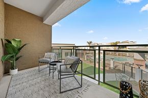 Glendale apartment for rent - a balcony with patio furniture and a view of a pool