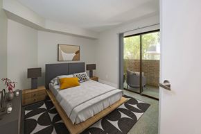 Westminster apartment for rent - A bedroom with a bed, nightstand, and chair.