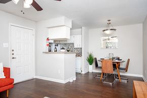 Houston apartment for rent - A kitchen with a red chair and a wooden table.