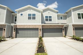 Pearland apartment for rent - A row of houses with garages in front.