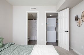 Metairie apartment for rent - A bedroom with a bed and a refrigerator in the closet.