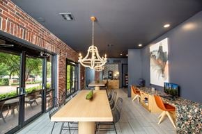 Houston apartment for rent - A modern dining room with a wooden table and chairs.