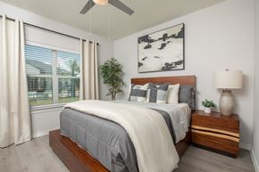 Porter apartment for rent - A bedroom with a bed, a ceiling fan, and a window with curtains.