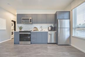 University Place apartment for rent - a kitchen with stainless steel appliances and gray cabinets