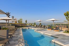 Washington apartment for rent - A pool with a blue tiled edge and a metal ladder.