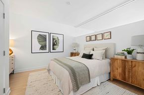 Washington apartment for rent - A bedroom with a bed, nightstand, and two framed pictures on the wall.