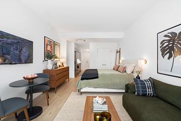 Washington apartment for rent - A living room with a green couch and a coffee table.