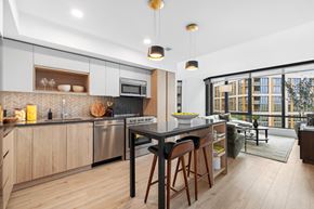 Washington apartment for rent - A modern kitchen with wooden cabinets and a large island.