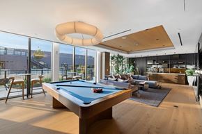 Washington apartment for rent - A pool table is in the middle of a room with a couch and a chair.
