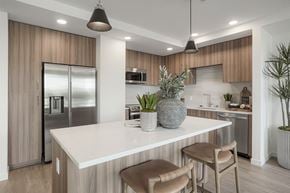 San Jose apartment for rent - the preserve at ballantyne commons open concept kitchen with island and stainless steel refrigerator
